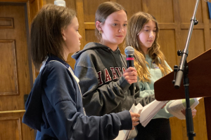 Students speaking at a lecturn